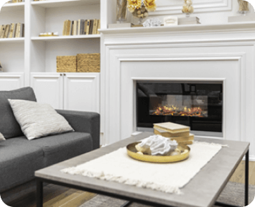 Bright living room with a gas ﬁreplace, neatly designed with a white mantel and clean lines in Stateline, CA.