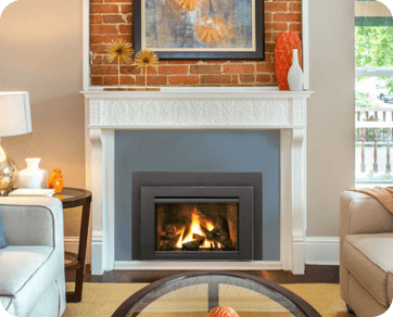Contemporary living room featuring a gas insert ﬁreplace with a white mantel and brick accents in Stateline, CA.