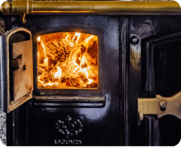 Cozy wood stove with ﬂames burning inside, providing warmth and ambiance in Stateline, CA